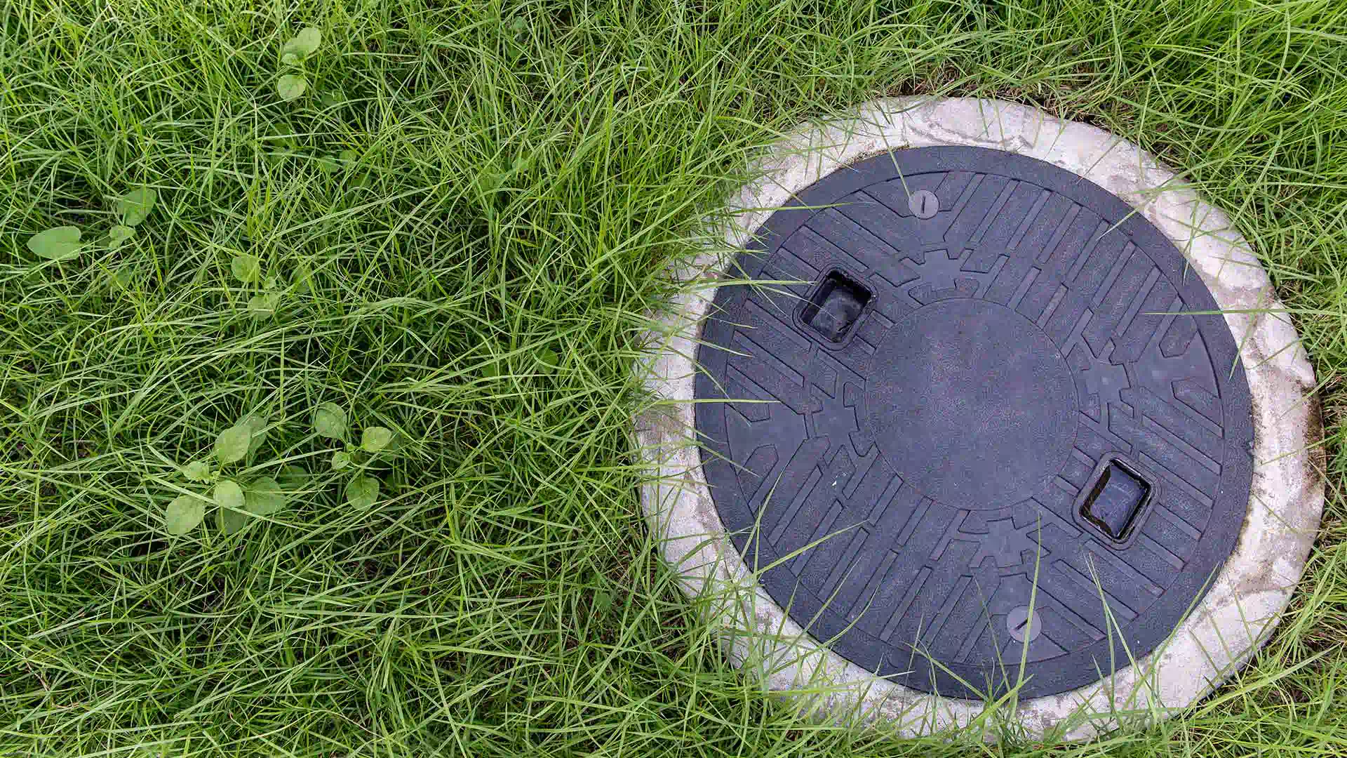 black septic cover in grassy area newaygo mi 1